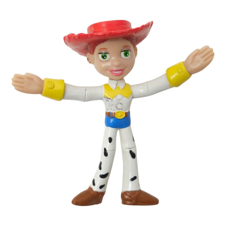 May include: A plastic figurine of a character from the Toy Story franchise. The figure is wearing a red hat, white shirt with yellow accents, blue belt, and white trousers with black spots. The figure's arms are outstretched.