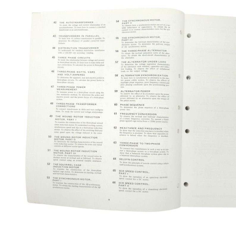 May include: Open textbook pages with technical titles like "The Autotransformer," "Three Phase Circuits," and "Synchronous Motor." The pages are white with black text and a few small illustrations. The book is open to a spread.
