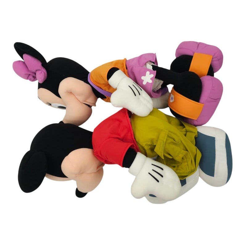 May include: Three plush toys of Mickey Mouse characters. One is Minnie Mouse wearing a pink and purple outfit, another is Mickey Mouse wearing a red and yellow outfit, and the third is Mickey Mouse wearing a blue and yellow outfit.