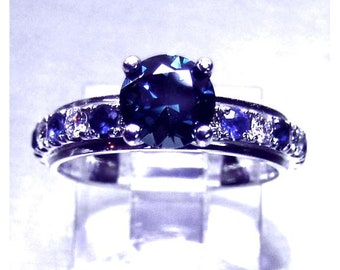 Ladies custom designed 14 karat white gold untreated top Montana VVS blue and teal blue color change  sapphire and diamond  engagement ring