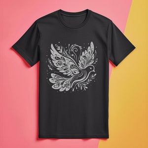 May include: Black t-shirt featuring a white stylised design of a bird with intricate details.