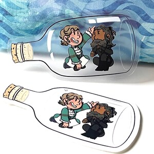 May include: Two cartoon characters are trapped inside a glass bottle. One character is wearing a green and white outfit and the other is wearing a black outfit. The bottle is clear and has a cork stopper.