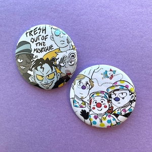 May include: Two circular badges with cartoon illustrations on a purple background. One badge features the text "FRESH OUT OF THE MORGUE" and several cartoon characters. The other badge has a clown theme with three characters.