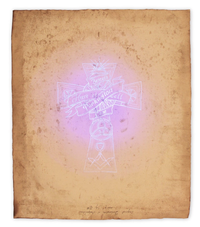 A prop of the Declaration of Independence showing the backside with an ornamental clue revealed through black light