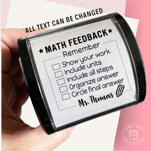 May include: A black rectangular stamp with the text "MATH FEEDBACK" and a checklist for math assignments. The stamp includes the text "ALL TEXT CAN BE CHANGED" and "Ms. Thomas". A pencil icon is also present.