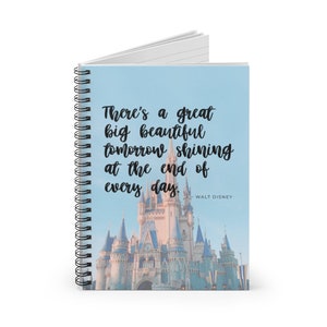 May include: A spiral bound notebook with a blue background and a picture of Cinderella's castle. The quote "There's a great big beautiful tomorrow shining at the end of every day." by Walt Disney is printed on the front.