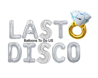 May include: Silver foil balloons spelling out "LAST DISCO" with a gold ring and a white diamond balloon on top.