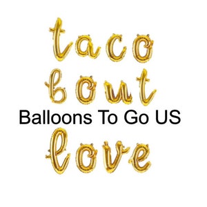 May include: Gold foil letter balloons spelling out "taco bout love". Balloons To Go US is printed below the balloons.