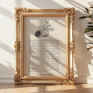 May include: A framed print with a gold, ornate frame. The print features a black and white illustration of figs and text from Sylvia Plath's "The Bell Jar". The text is centered on a cream-coloured background.