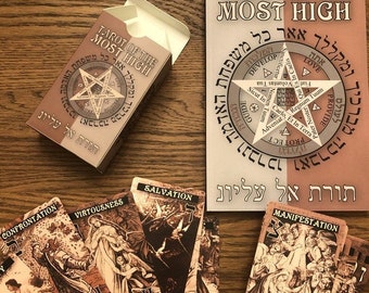 May include: A tarot deck box with the title "Tarot of the Most High" in Hebrew and English. The box is brown with a gold star and Hebrew text. The cards are spread out on a wooden surface. The cards feature illustrations of people and scenes.