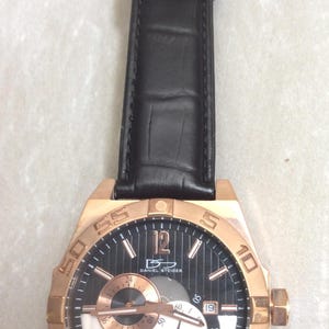 DANIEL STEIGER automatisch roségouden herenhorloge, ronde zwarte en zilveren chronograaf wijzerplaat op zwarte leren band Nieuw ongebruikt vintage horloge!