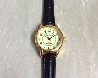 MIYKON Gold Women's Watch Round Glow Dial Black Numbered Hours on a Black Leather Band Unused New Vintage Item Ready to be Cherished!