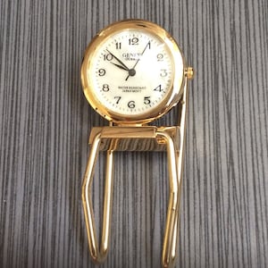 Fermasoldi e orologio da uomo in oro di Ginevra, articolo vintage unico, ancora nuovo, pronto per essere apprezzato e custodito con cura!