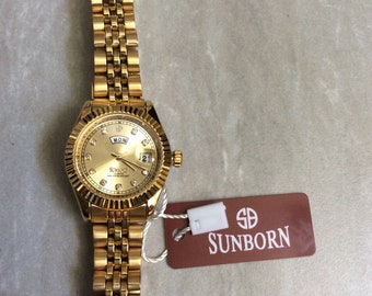 SUNBORN Gold Women's Watch Round Gold Dial Crystal Hour Markers Day and Date Indicators on a Gold Linked Band Unused New Vintage Item Beauty