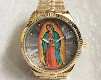 MIYKON Men's Religious Watch having a Round Silver Sunray Guadalupe Dial Crystal Hour Marker's Gold Stretch Band Unused New Vintage Watch!