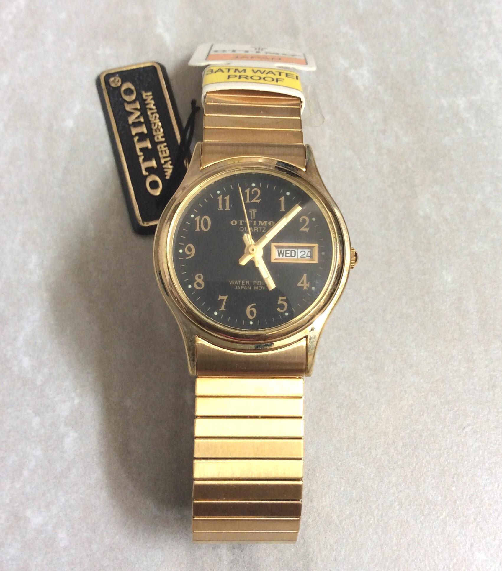 OTTIMO Gold Damen-Armbanduhr Gold Rund Schwarzes Zifferblatt Gold Stunden  auf einem flachen Gold Stretch Band Neu Unbenutzt Vintage Artikel