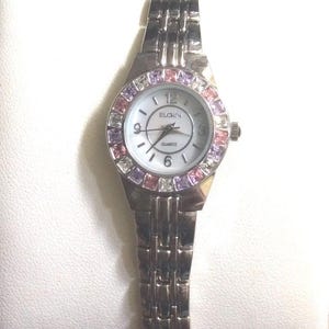 ELGIN Women&#39;s Silver Watch Multicolored Crystal Round White Dial Arabic Numerals and Index Hour Markers on Silver Link Band New/Vintage Item