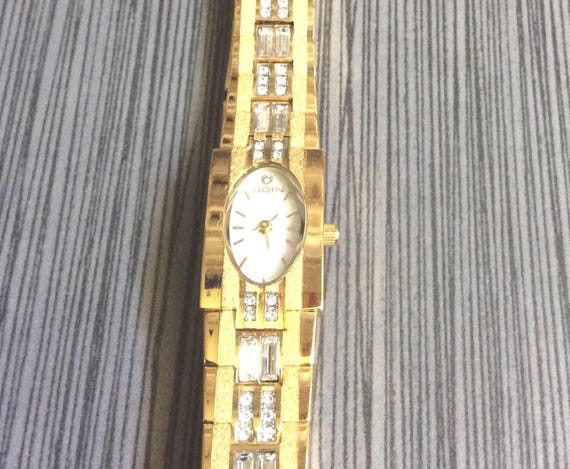 Elgin Women's Gold Crystal Watch Having a Oval Pearl Dial Index Crystal  12th Hour Markers on a Crystal Gold linked Band New Unused Vintage