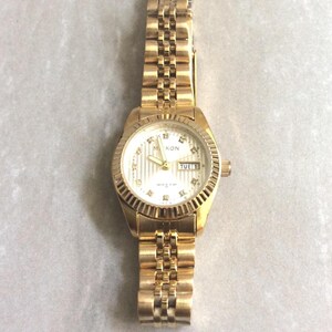 MIYKON Damen Gold RX Uhr Rundes silbernes Zifferblatt Day & Datum Kristall Stunden auf Gold Linked Band Neuer unbenutzter Vintage-Artikel Bereit, in Wert gehalten zu werden!