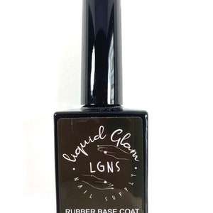 May include: A black bottle of nail polish with a black label that says "liquid Glam. LGNS. nail supply. RUBBER BASE COAT. 15ml-0.5fl.oz.e"