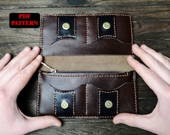 May include: A brown leather wallet with a zippered compartment and multiple card slots. The wallet has a black leather interior and is open to reveal the interior.