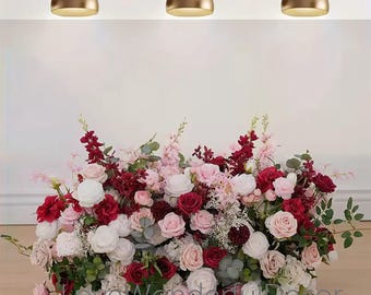 May include: A large floral arrangement with pink, white, and red roses, greenery, and other flowers. The arrangement is perfect for a wedding or other special event.
