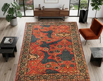May include: A rectangular, red oriental rug with a detailed floral and bird design. The rug features a central field of red with blue and gold accents, and a dark border. The rug is placed on a hardwood floor in a well-lit room.
