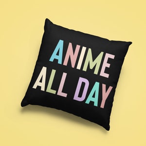 May include: Black square pillow with the text "ANIME ALL DAY" in pastel colors. The letters are in a sans-serif font. The pillow is on a yellow background.