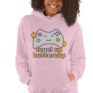 May include: Pink hoodie with a cartoon video game controller and the text "level up buttercup" in rainbow colors.
