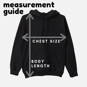 May include: A black hooded sweatshirt with a pocket on the front. The image shows how to measure the chest size and body length of the sweatshirt.