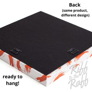 May include: The back of a canvas art piece, ready to hang. The back is black, with two metal brackets for hanging. The edges are white with orange brushstroke designs. Text on the image reads "Back (same product, different design)" and "ready to hang!"