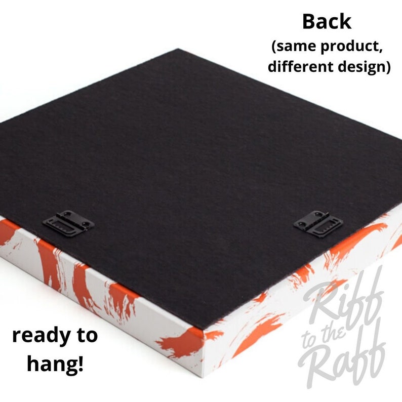 May include: The back of a canvas art piece, ready to hang. The back is black, with two metal brackets for hanging. The edges are white with orange brushstroke designs. Text on the image reads "Back (same product, different design)" and "ready to hang!"