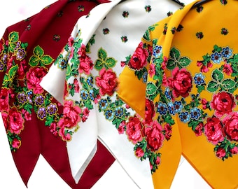 May include: Three floral patterned scarves in red, white, and yellow. Each scarf features a repeating pattern of roses and smaller flowers.