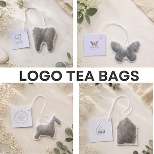 May include: Four custom-shaped tea bags with white strings and attached square paper tags. The shapes include a tooth, a butterfly, a dog, and a house. Each tag features a unique logo and text, including Dentist, Butterfly, and The House.