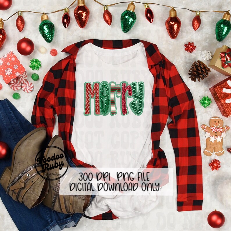 May include: A white t-shirt with the word "Merry" in red, green, and white patterned letters. The shirt is laid out on a red and black plaid shirt with Christmas decorations around it.