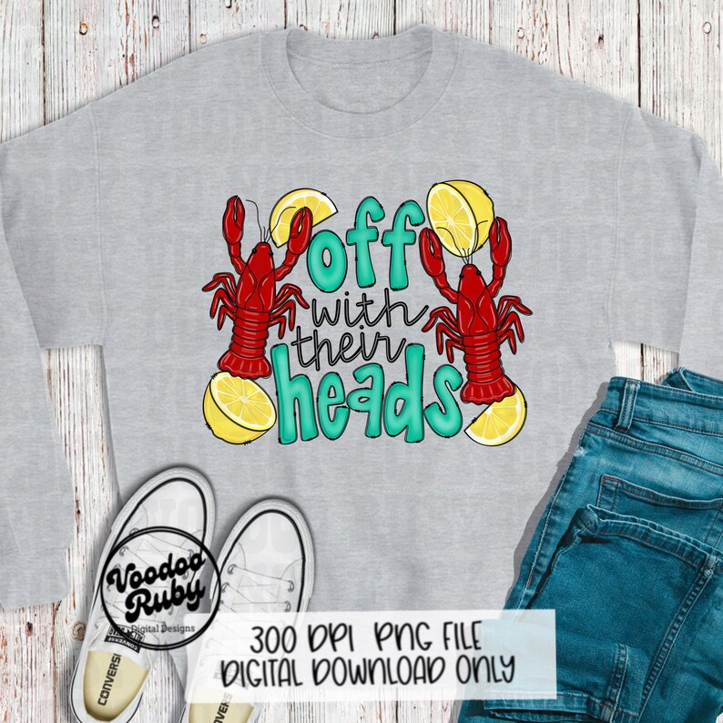 May include: A gray sweatshirt with the text "Off with their heads" in teal lettering. Two red crawfish are on either side of the text, each with a lemon wedge on top.