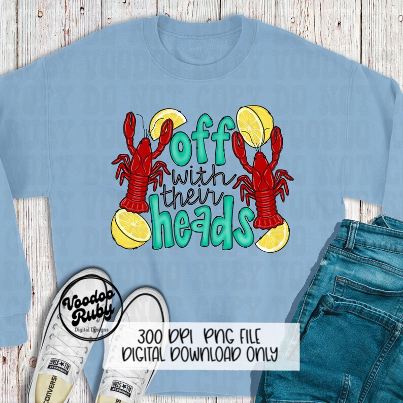 May include: A light blue sweatshirt with a graphic design of two red crawfish with lemons and the text "Off with their heads".