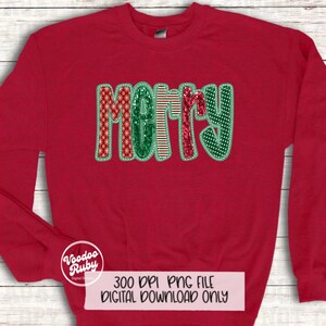 May include: Red sweatshirt with a festive "Merry" design featuring a variety of Christmas patterns and sequins. The design is in green, red, and white.