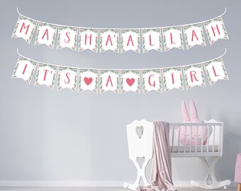 May include: White banner with green floral accents and pink lettering that reads "Masha'Allah It's a Girl".