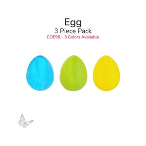 May include: Three colorful egg-shaped objects in blue, green, and yellow. The text "Egg 3 Piece Pack" is above the eggs, with "COE96 - 3 Colors Available" below. A small butterfly graphic is in the lower left corner.