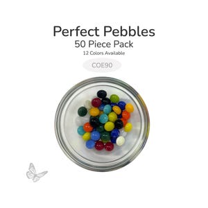 May include: A clear glass bowl filled with 50 colorful glass pebbles. The pebbles are in various colors, including red, blue, green, yellow, and black. Text above the bowl reads "Perfect Pebbles" and "50 Piece Pack".