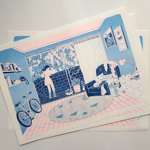 May include: A screen print illustration in blue and pink tones depicting an interior room with a person standing by a large window, a bicycle, a patterned rug, an armchair with a cat, a lamp, and wall art, with numbered editions visible.