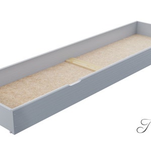May include: A light grey wooden drawer with a light brown fabric lining. The drawer is open and the lining is visible.