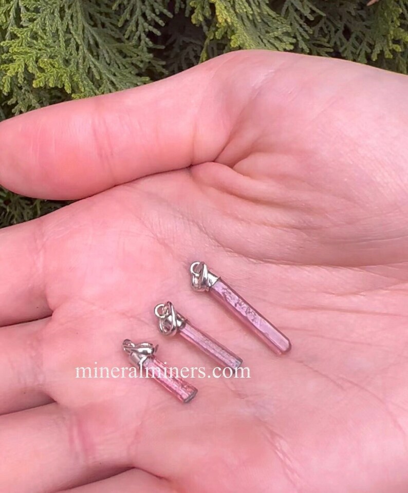 Pink Tourmaline Crystal Pendants in Sterling Silver on Hand, photo was taken inside outside under indirect sunlight.