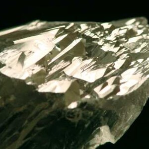 Close up view of Natural Gemmy Yellow Kunzite Crystal, photo was taken inside under fluorescent lights.