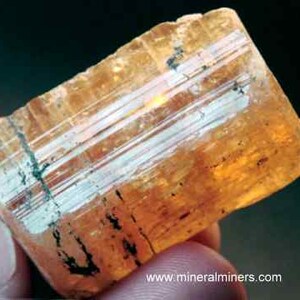 Natural Imperial Topaz Crystal, photo was taken inside under fluorescent lights.