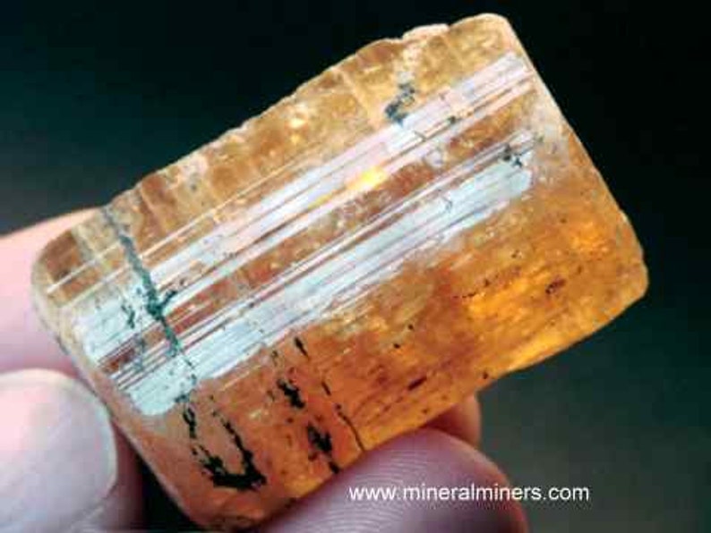 Natural Imperial Topaz Crystal, photo was taken inside under fluorescent lights.
