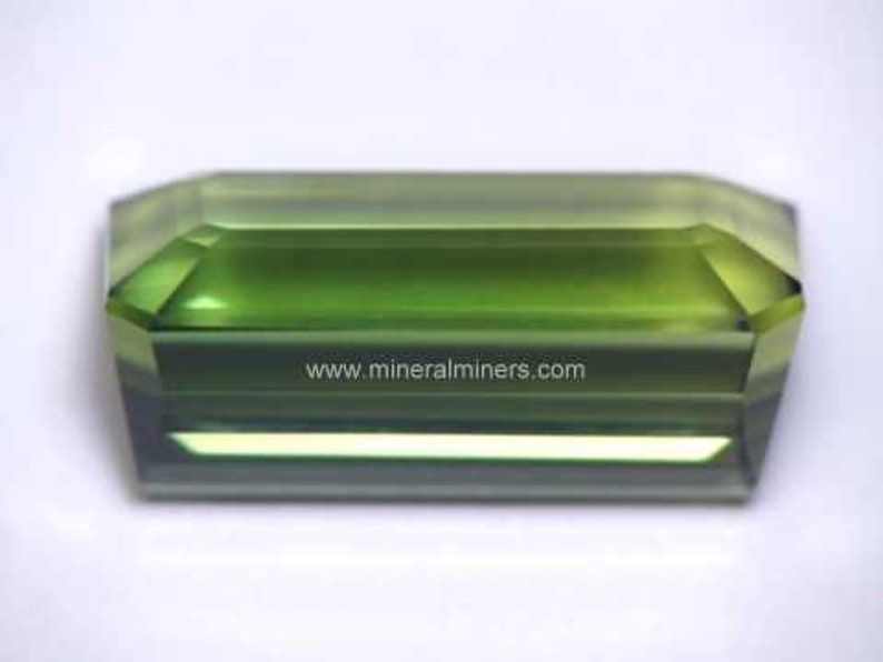 Side view of Flawless Large Green Tourmaline Gemstone - photo was taken inside under fluorescent lights.