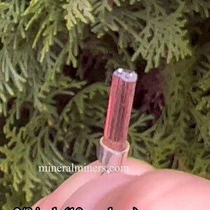 May include: A pink and white crystal point with a silver cap, measuring 3/8 inch (10mm) long. mineralminers.com