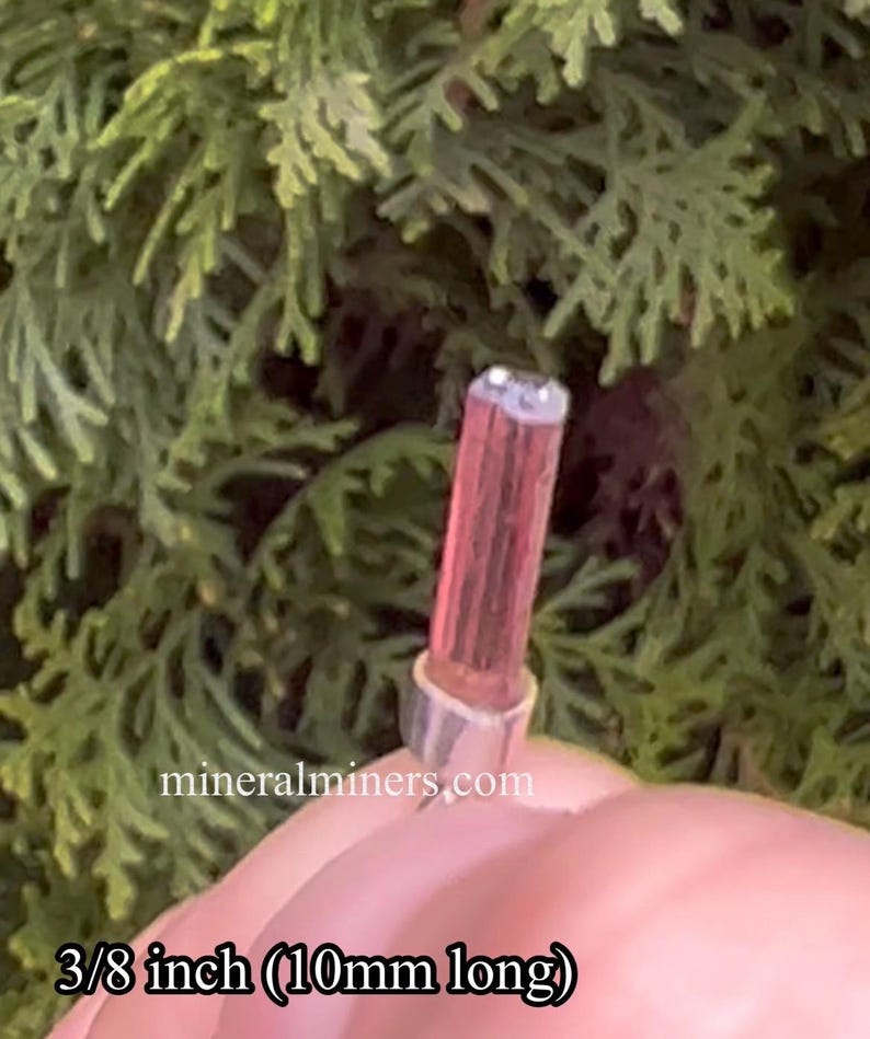 May include: A pink and white crystal point with a silver cap, measuring 3/8 inch (10mm) long. mineralminers.com